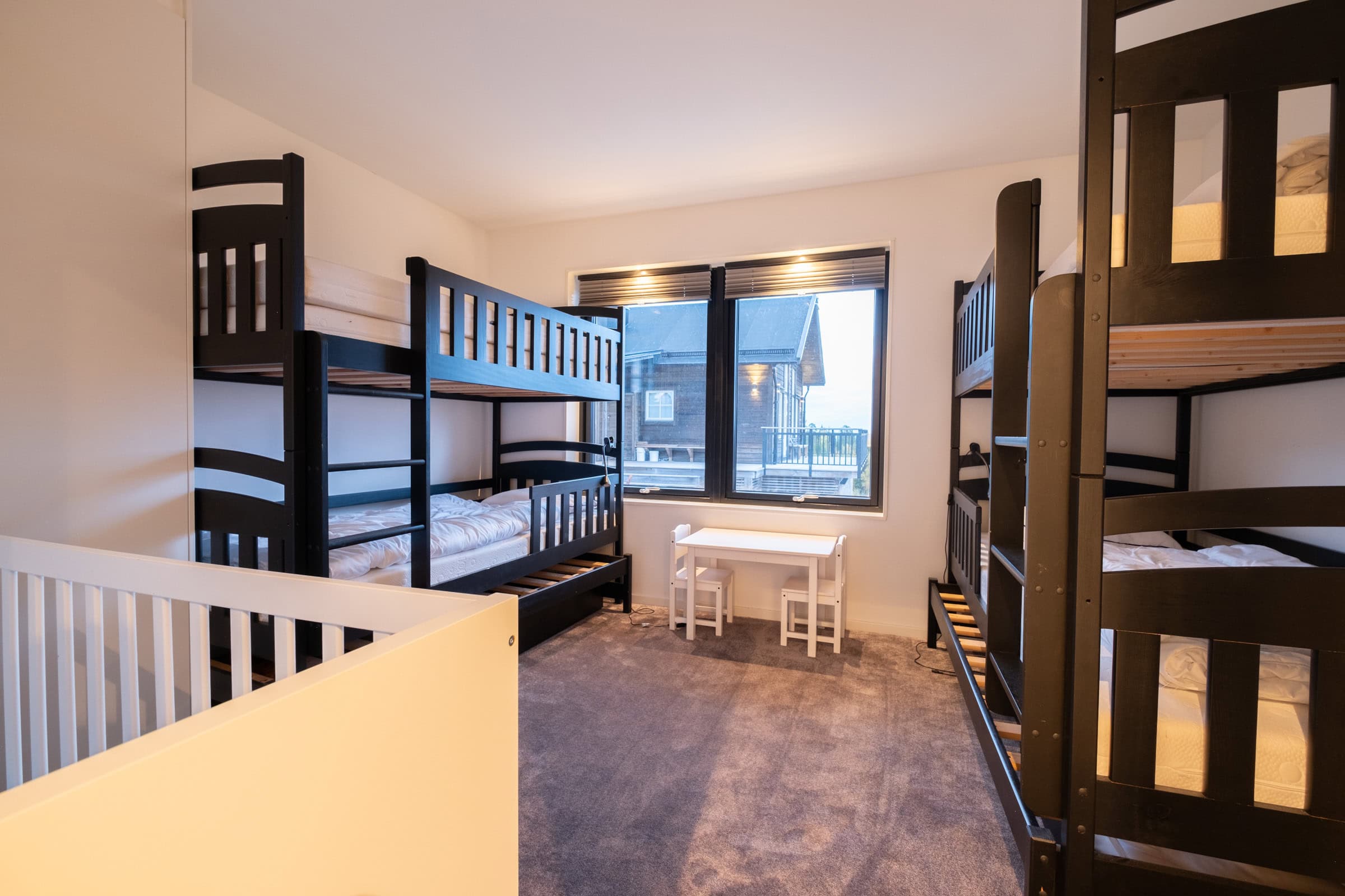The children’s room with two bunk beds and a window overlooking the grounds.