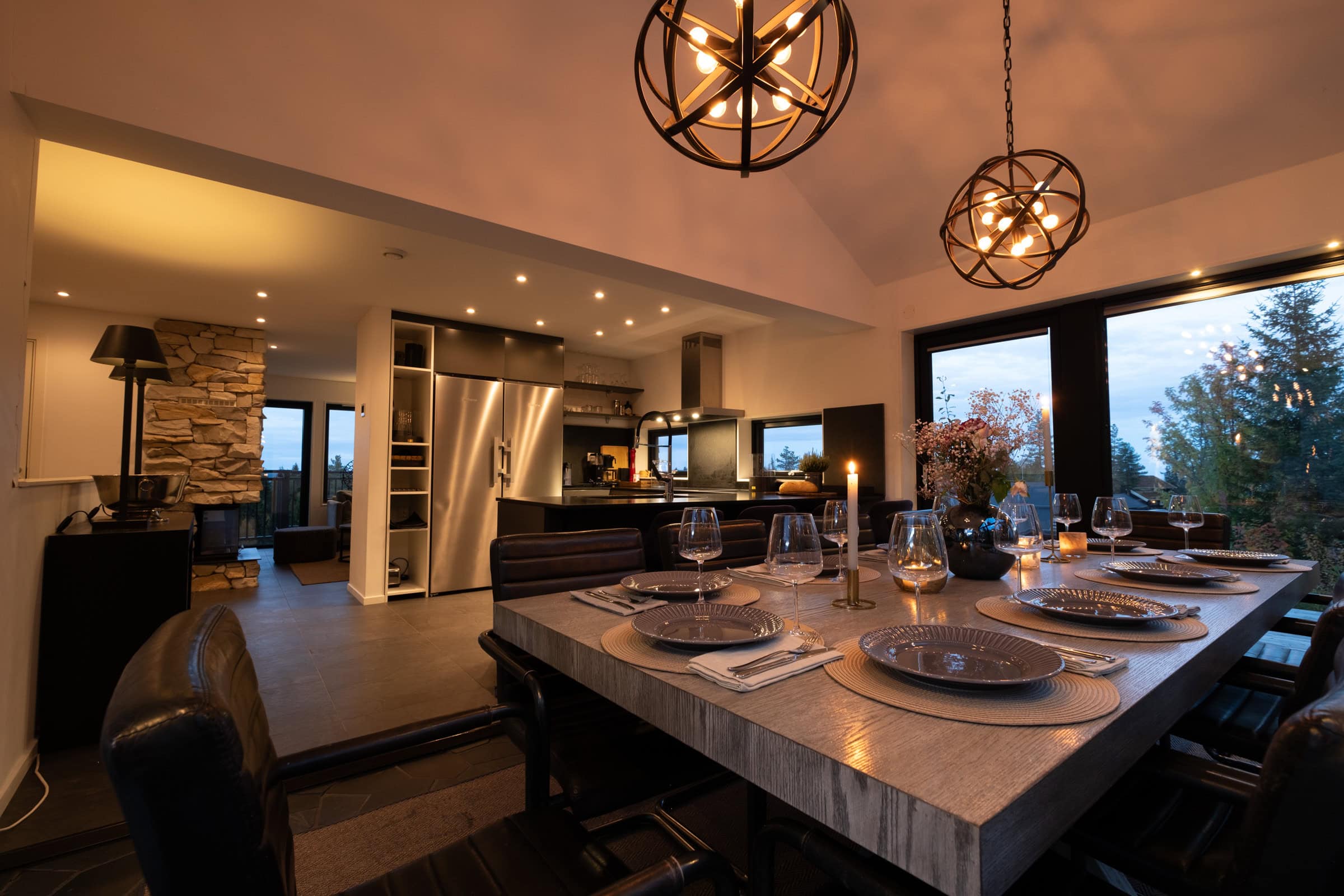 The dining area as seen from the living room one evening, with the kitchen in the background.