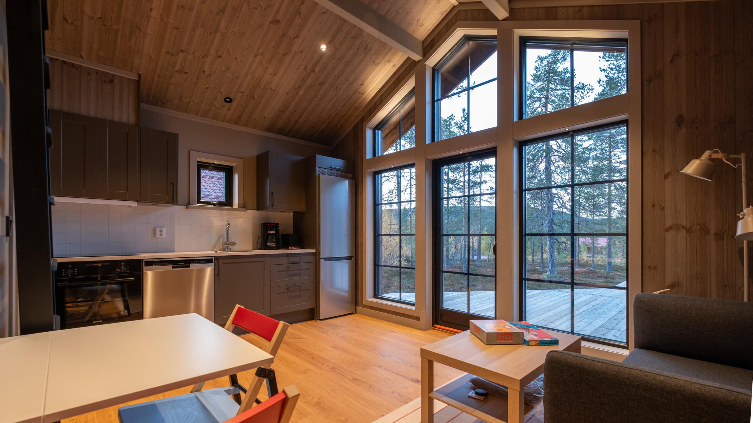 The kitchen and family room in the Attefall house, with tall windows overlooking the terrace