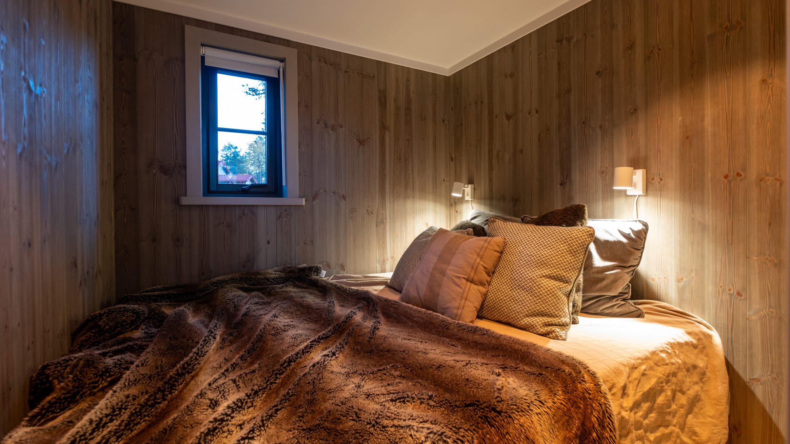 The bedroom in the Attefall house, with a double bed under a sloping ceiling