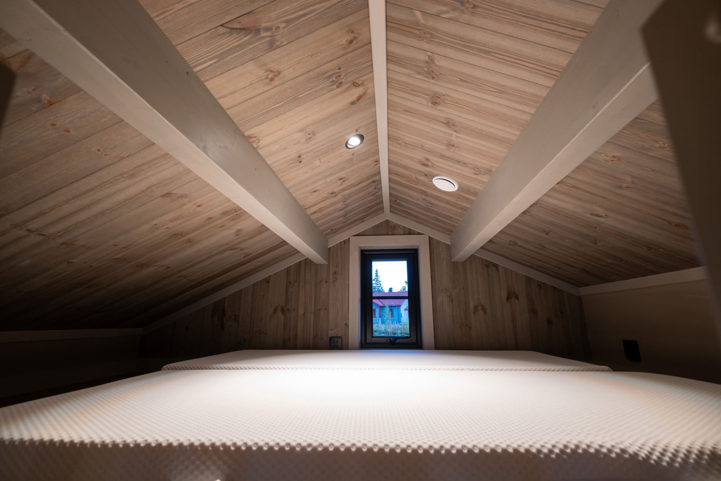 Loft bed in the Attefall house with a mattress under the ridge