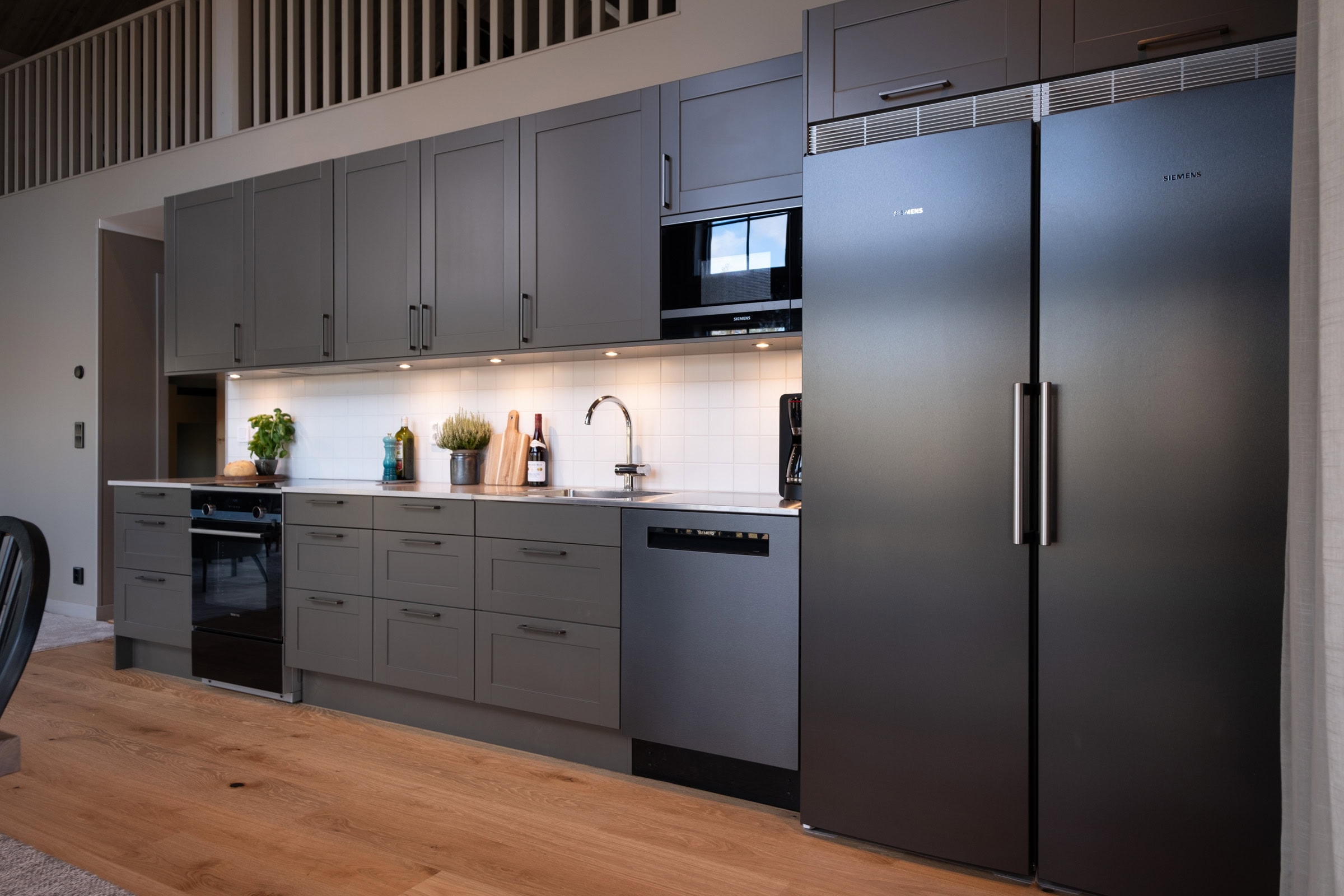 Kitchen with a double-door fridge-freezer and an induction hob