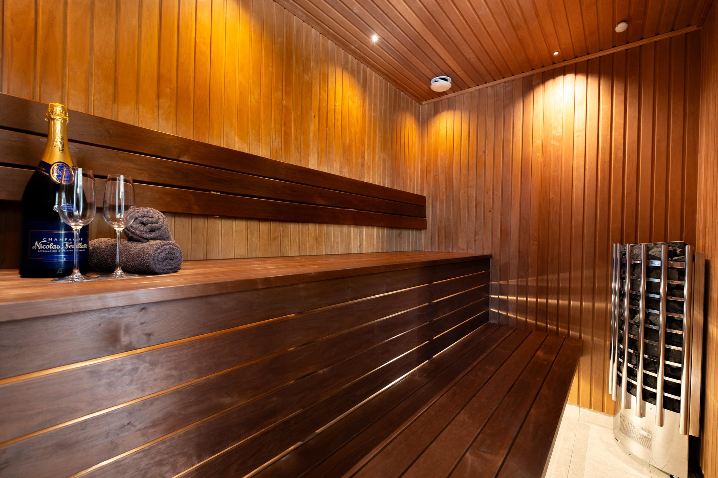 Sauna made from heat-treated timber, with lichen and a sauna heater